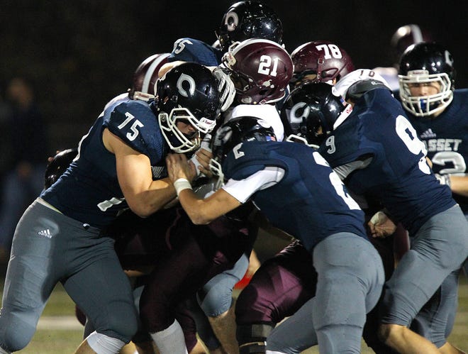 Cohasset defenders gang up to tackle Josh Pierre-Charles. Cohasset hosted Millis-Hopedale in a tournament sectional semi-final football game, Friday, Nov. 6, 2015. The Skippers are gearing up to play Hull Thanksgiving Day. 

Wicked Local Staff Photo/Gary Higgins