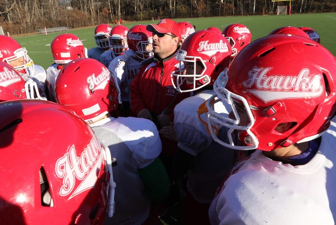 Waltham High School football coach John Bourque talks to his team during practice Monday afternoon. Wicked Local Staff Photo/Ann Ringwood