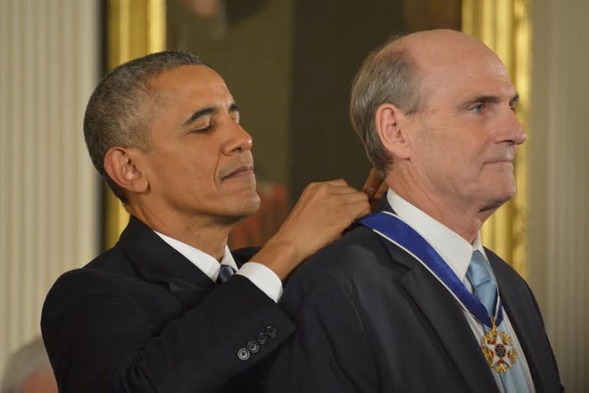 President Barack Obama awards singer James Taylor the Presidential Medal of Freedom, Tuesday, Nov. 24, 2015, during a ceremony in the East Room at the White House in Washington. (AP Photo/Andrew Harnik)