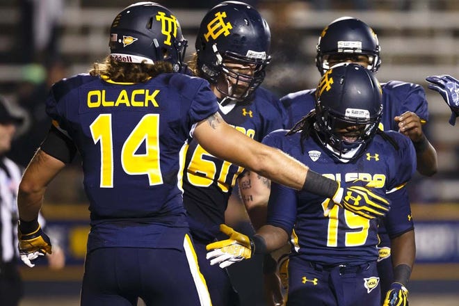 Toledo wide receiver Cassius McDowell (19) receives congratulations from wide receiver Justin Olack (14) after scoring a touchdown against Ball State in the second quarter of an NCAA college football game in Toledo, Ohio, Tuesday, Nov. 6, 2012. Ball State won 34-27. (AP Photo/Rick Osentoski)