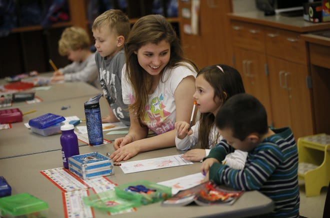 Kenyon College sophomore Meridith Heckler, 19, an American studies major, works with        kindergartner Kendall Griffith, 6, as they draw turkeys at East Knox Elementary School.