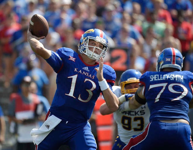Kansas freshman quarterback Ryan Willis, left, struggled last week against West Virginia. He completed just 13 of 36 passes for 127 yards and two picks in a 49-0 loss.
