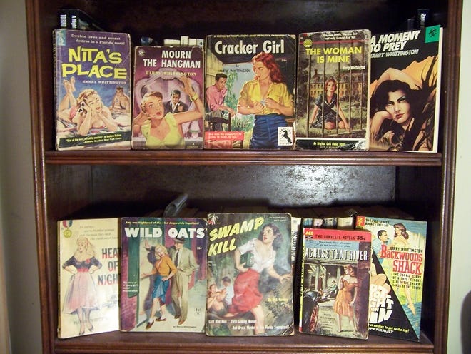 Harry Whittington's books had bright, flimsy covers featuring impossibly voluptuous women and scenes of wild mayhem. (Photo courtesy of Joshua Braley)