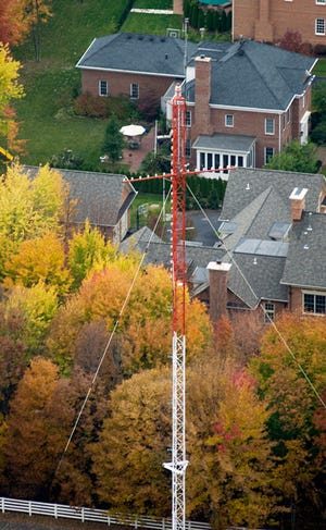 This 2004 file photo shows the cross-topped radio tower for WCVO (104.9 FM), a Christian radio station, when it was located near a New Albany neighborhood.