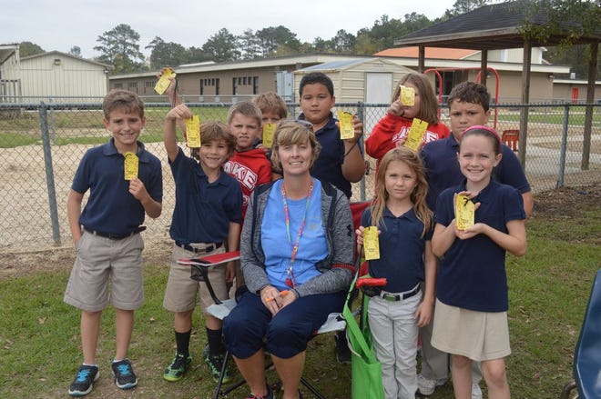 Sandy Lightfoot and students pose with resource pack items.