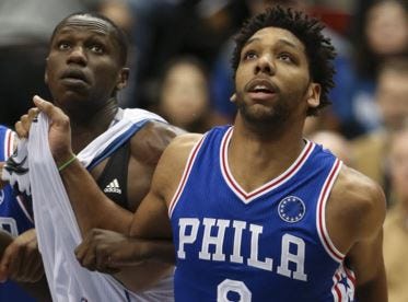 The 76ers' Jahlil Okafor, right, tangles with the Timberwolves' Gorgui Dieng during a game Monday in Minneapolis.