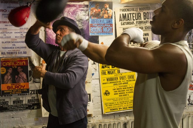 Rocky (Sylvester Stallone) gives Donny (Michael B. Jordan) a few tips on the speed bag.