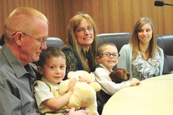 James Shears and his fiancée, Lynda Hart, became parents to 3-year-old Jackson (seated in Shears' lap) during Tuesday's Adoption Day celebration in St. Joseph County Probate Court. The Centreville couple will be adopting Jackson's older brother as soon as paperwork is in order. Joining them is their caseworker, Jamie Bartow, from Bethany Christian Services.