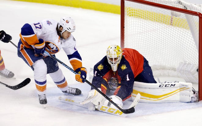 Panthers goalie Roberto Luongo makes a save on the Islanders' Matt Martin (17) during the first period Friday night in Sunrise, Fla. The Associated Press