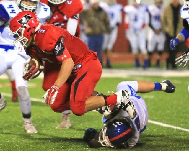 Ruby Dean • Special To Times Record Poteau’s Roger Barcheers is tripped up by Harrah’s Jeremy McDonald after getting a first down on Friday, Nov. 20, 2015 at Costner Stadium in Poteau.