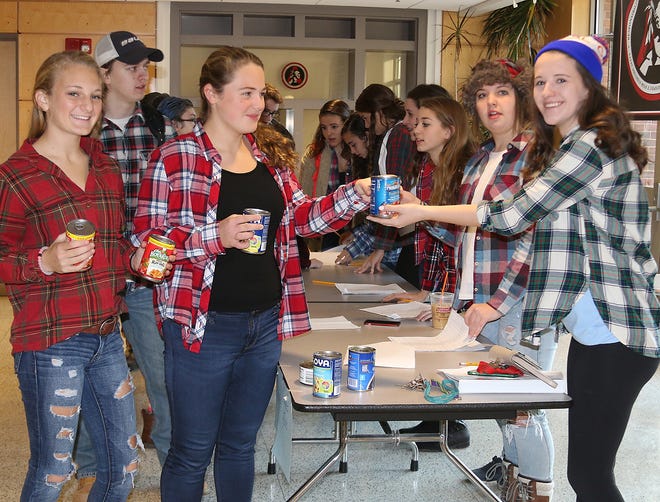 It was “Lumberjack Day” for spirit week at Amesbury High School. Pictured during the food drive to help Our Neighbors’ Table are Chelsea Lynch, left; Sydney Daileanes in the middle, and Maeve Cronin, right. Courtesy Photo