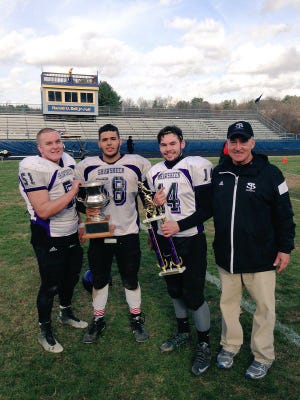 Senior captains (from left) Alex Regan, John Schiavo and Alex Tate (game MVP) stand with head coach Al Costabile after Thursday's Thanksgiving Day win for the Rams. COURTESY PHOTO