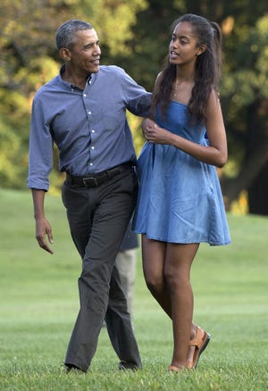 In this photo taken Aug. 23, President Barack Obama and his daughter Malia walk across the South Lawn of the White House in Washington from Marine One. The 17-year-old is among the millions of U.S. high school seniors who are nervously taking standardized tests, completing college admissions applications, filling out financial aid forms and writing personal essays, all on deadline, before spending the coming months anxiously waiting to find out if they got into their dream school. (AP Photo/Carolyn Kaster)