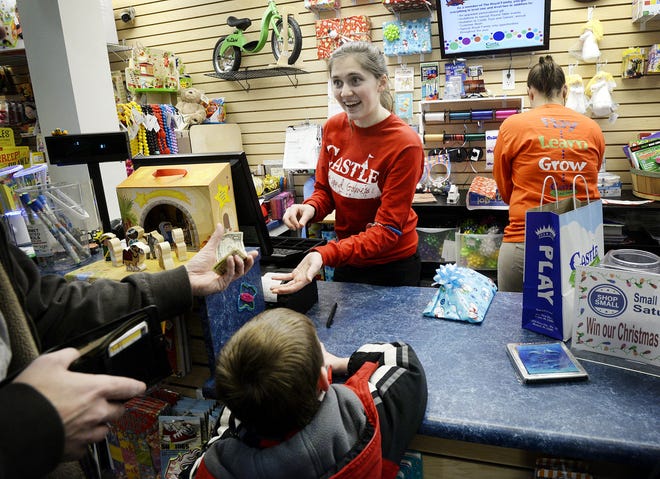 Local store owners benefit from Small Business Saturday sales. Emily Billheimer waits on a customer at Castle Toys and Games in Beaver in November 2014.