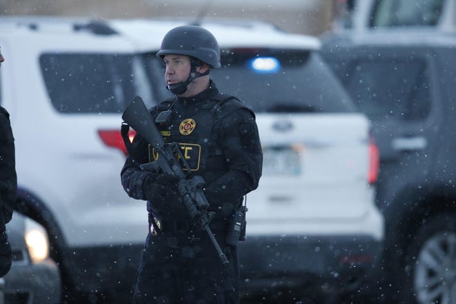 Police stand guard at the intersection of Centennial and Fillmore near a Planned Parenthood clinic Friday, Nov. 27, 2015, in Colorado Springs, Colo. A gunman opened fire at the clinic on Friday, authorities said, wounding multiple people. (AP Photo/David Zalubowski)