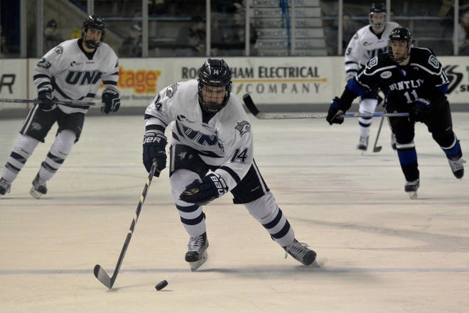 Maxim Gaudreault skates the puck into New Hampshire's attacking zone during Saturday's 5-4 win over Bentley at the Whittemore Center in Durham. Drew Hallett/Fosters.com