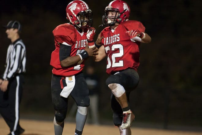 South Point's Ryland Etherton (32) and Diontrea King (7) celebrate during the team's 28-27 win over West Rowan Friday night.