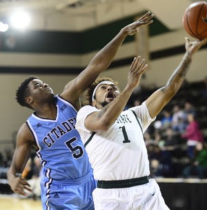 The Citadel's Warren Sledge (5) tries to stop USC Upstate's Mike Cunningham (1) from going to the basket during Saturday's game at the Hodge Center. ALEX HICKS JR/alex.hicks@shj.com