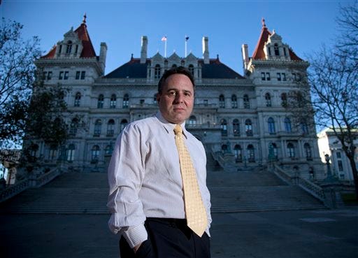 In this Nov. 23, 2015 photo, College of Saint Rose professor Bruce Roter, founder and president of the Museum of Political Corruption, poses outside the state Capitol in Albany, N.Y. Roter envisions a museum that would not only detail Albany’s many political scandals but also offer some possible solutions to corruption. (AP Photo/Mike Groll)