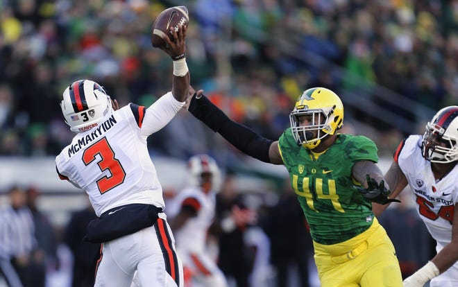 Oregon defensive lineman DeForest Buckner rushes Oregon State quarterback Marcus McMaryion leading to an Oregon State interception in the first quarter of the 119th Civil War football game at Autzen Stadium in Eugene on Friday, November 27, 2015. (Andy Nelson/The Register-Guard)