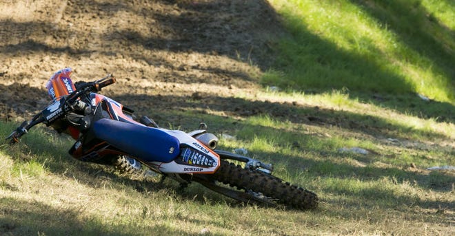 A bike belonging to a super-cross rider lays off to the side of the track at Gatorback Cycle Park on Monday after a crash required the rider to be airlifted to the hospital.