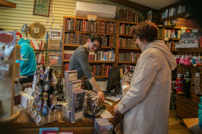 Sean Jahn rings up customers at Ye Olde Warwick Book Shoppe on Small Business Saturday in Warwick on Saturday. Allyse Pulliam/For the Times Herald-Record