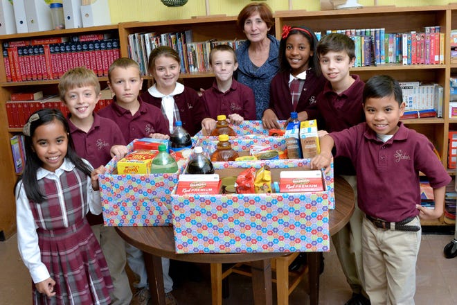Students, faculty and families connected with St. Johnís School in Goshen have kept a Thanksgiving tradition alive. By collecting nonperishable food they were able to fill 25 boxes with items that will get a family through the long holiday weekend. Photo provided