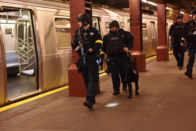 FILE - In this Sunday Nov. 22, 2015, file photo, provided by the New York Police Department, police stage a drill simulating an attack in an abandoned subway station in New York. Since the Paris attacks, U.S. police officials and security experts have been hammering home the hard realities of so-called "active shooter" incidents. Officials believe the best chance to preserve life is for ordinary police officers not to hesitate to charge in and kill the attackers. (New York Police Department via AP)