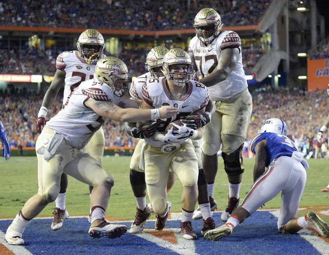 Phelan M. Ebenhack Associated Press Florida State tight end Jeremy Kerr (center) celebrates with teammates after scoring a touchdown against Florida on a 1-yard pass play during the first half on Saturday night in Gainesville.