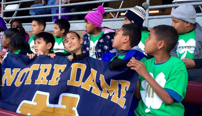 Taylor Leadership Academy third-grade students sit in anticipation of the start of the game between Notre Dame and Stanford on Saturday. The class has adopted the University of Notre Dame as their own to increase college awareness, and for many, it was their first game. ALMENDRA CARPIZO/THE RECORD