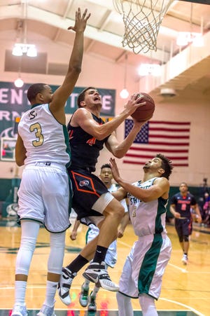 Pacific Tigers forward Tonko Vuko (4) drives to the basket during the second half Sunday in Sacramento. BRIAN BAER/FOR THE RECORD