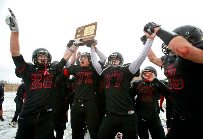 The Rossville Bulldawgs hoist the 3A state championship trophy Saturday after defeating Collegiate 20-19.