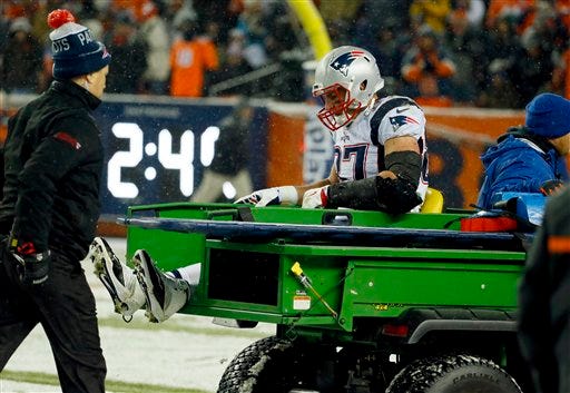 New England Patriots tight end Rob Gronkowski is carted off the field after being injured against the Denver Broncos during the second half of Sunday's game. The Associated Press