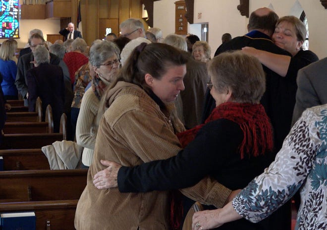 Worshipers hug during the service on Sunday, Nov. 30, 2015, at First Presbyterian Church of Willow Grove. The congregation will merge with Warminster Presbyterian Church in December.