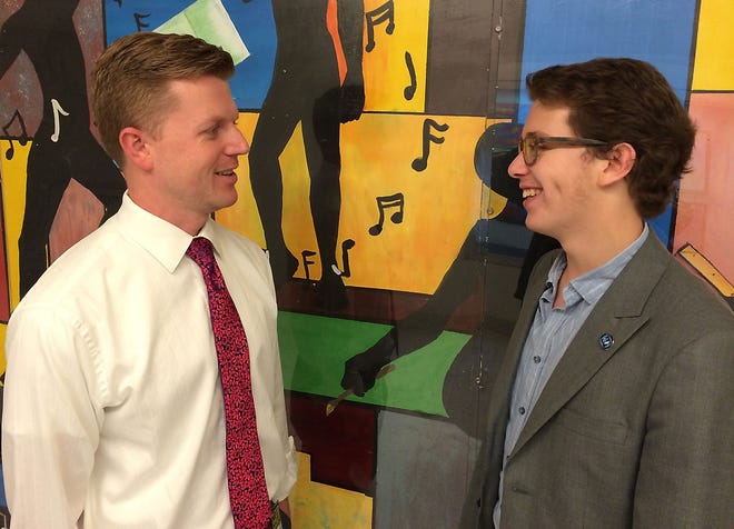 Robert Joubert, director of choral activities at Shawnee High School, speaks with senior Aidan Vogel, of Medford, about the student's successful bid to join the All-State Jazz Choir.