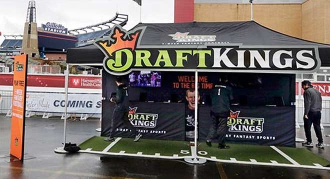 Workers set up a DraftKings promotions tent in the parking lot of Gillette Stadium, in Foxborough, Mass., before an NFL football game last month between the New England Patriots and the New York Jets.