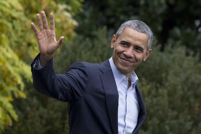 President Barack Obama waves as he walks across the South Lawn of the White House to board Marine One, Sunday, Nov. 29, 2015, in Washington, for the short trip to Andrews Air Force Base, Md., and on to Paris where the president is to meet with other world leaders at the climate talks. (AP Photo/Carolyn Kaster)