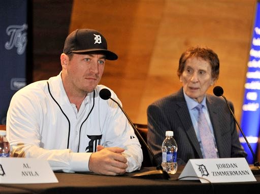 Detroit Tigers pitcher Jordan Zimmermann, left, answers questions next to team owner Mike Ilitch, right, during a news conference in Detroit on Nov. 30, 2015. Free agent Zimmermann has finalized a $110 million, five-year contract with the team.