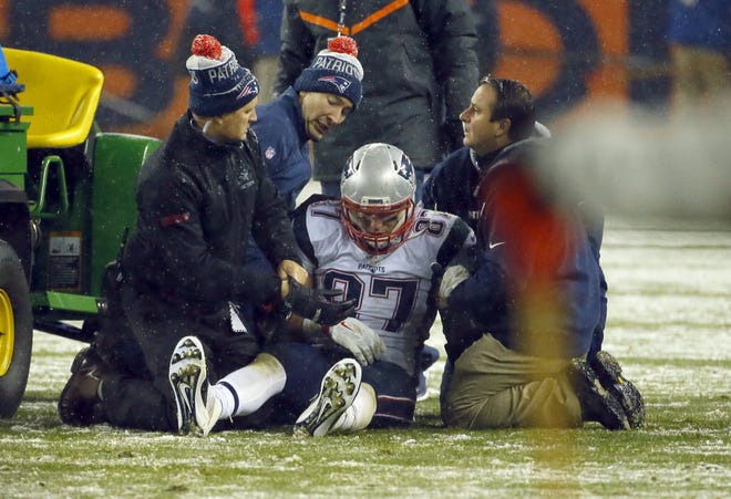Rob Gronkowski receives medical attention after being injured in the fourth quarter of Sunday night's game in Denver.