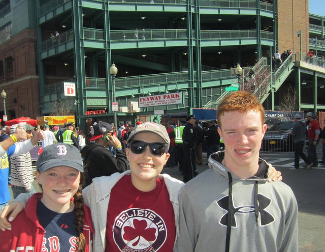 Anna, center, stands with her sister Emily and twin brother Will at Fenway Park in 2014. Courtesy photo