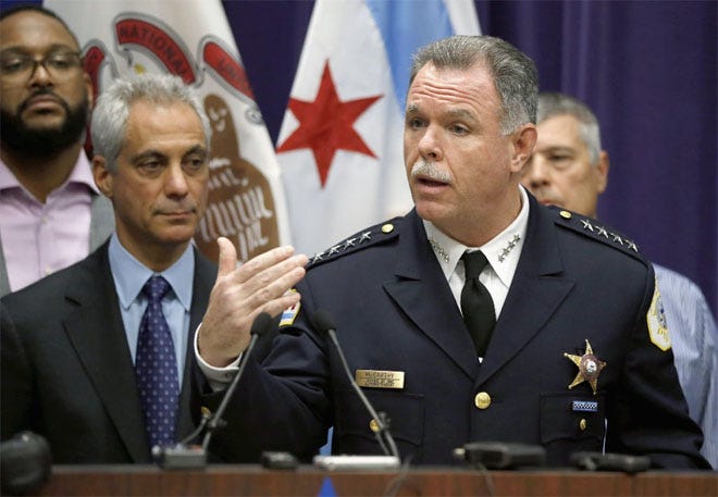 Chicago Police Superintendent Garry McCarthy, right, speaks as Mayor Rahm Emanuel looks on at left.