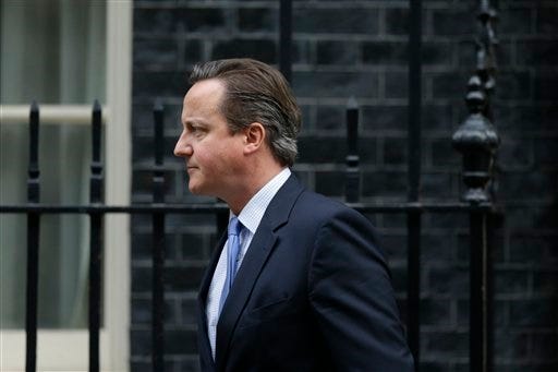 British Prime Minister David Cameron leaves 10, Downing Street in London, to go to the Houses of Parliament for a debate and vote on launching airstrikes against Islamic State extremists inside Syria, Wednesday, Dec. 2, 2015. The vote expected Wednesday evening would authorize bombing inside Syria. Britain has been participating in U.S.-led coalition attacks against IS positions in Iraq only. (AP Photo/Matt Dunham)