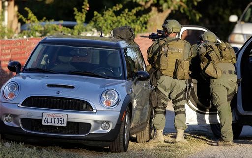 People are evacuated by law enforcement agencies from the Inland Regional Center the scene of a shooting in San Bernardino, Calif. on Wed. Dec. 2, 2015. Police in San Bernardino, California, were responding to reports of an active shooter at a social services facility. There were reports of multiple victims, Lt. Rich Lawhead said Wednesday.