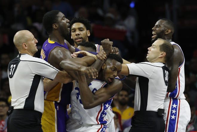 The Sixers' Jahlil Okafor (back) tries to break up a scuffle between the Lakers' Roy Hibbert (left) and the Sixers' Jerami Grant (second from right) and JaKarr Sampson (right) during Tuesday night's game.