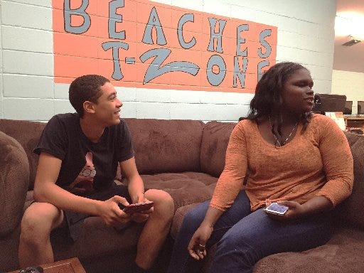 Keith Gooch, 14, and Kaitlyn Neal, 15, talk to friends in the newly remodeled teen space at the Beaches Boys & Girls Club in Jacksonville Beach. The club recently received a $20,000 makeover of its teen space, including new electronics and furniture, through a partnership with Boys & Girls Clubs of America and Aaron's Inc.