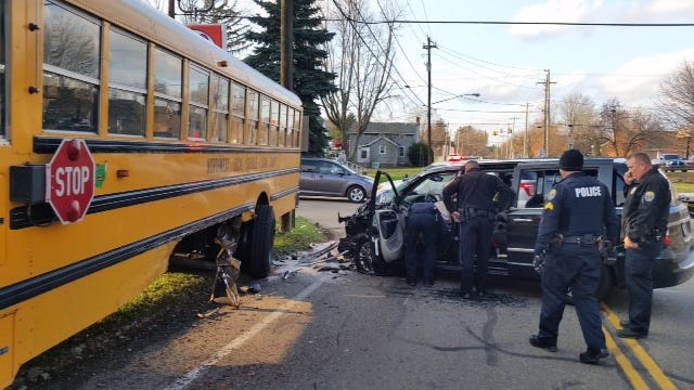 Canal Fulton and Lawrence Township police survey the scene after a Hinckley man fleeing police crashed into a school bus on South Locust Street on Wednesday afternoon.