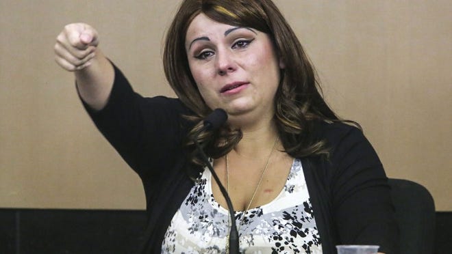 Vanessa Vandermeeren-Sanchez demonstrates how she says Paul Charles stabbed her boyfriend Matthew Snow as she testifies against Charles in his murder trial Wednesday morning, December 2, 2015. Charles allegedly stabbed Snow and Vandermeeren-Sanchez in 2013 after threatening Sanchez several times in the past. Snow died following the stabbing. (Lannis Waters / The Palm Beach Post)