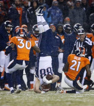 Scott Chandler lands head-first after making a catch in the second half of Sunday's game in Denver.
