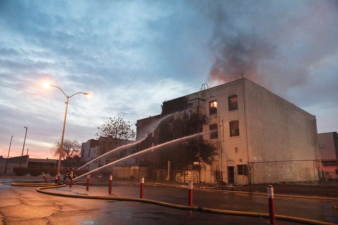 Stockton firefighters continue to put water on the La Verta Hotel at sunrise Thursday after fire broke out at the long-abandoned building just before 4 a.m. Part of the former Katten Building at 635 E. Main St., the structure is a complete loss. CRAIG SANDERS/FOR THE RECORD