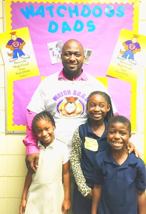 WATCH D.O.G.S dad Leon Pitts stands with and his three children who are students at Emma E. Booker Elementary School, from left, first-grader Zoriah Pitts, second-grader Acacia Pitts and kindergartner Zion Pitts.